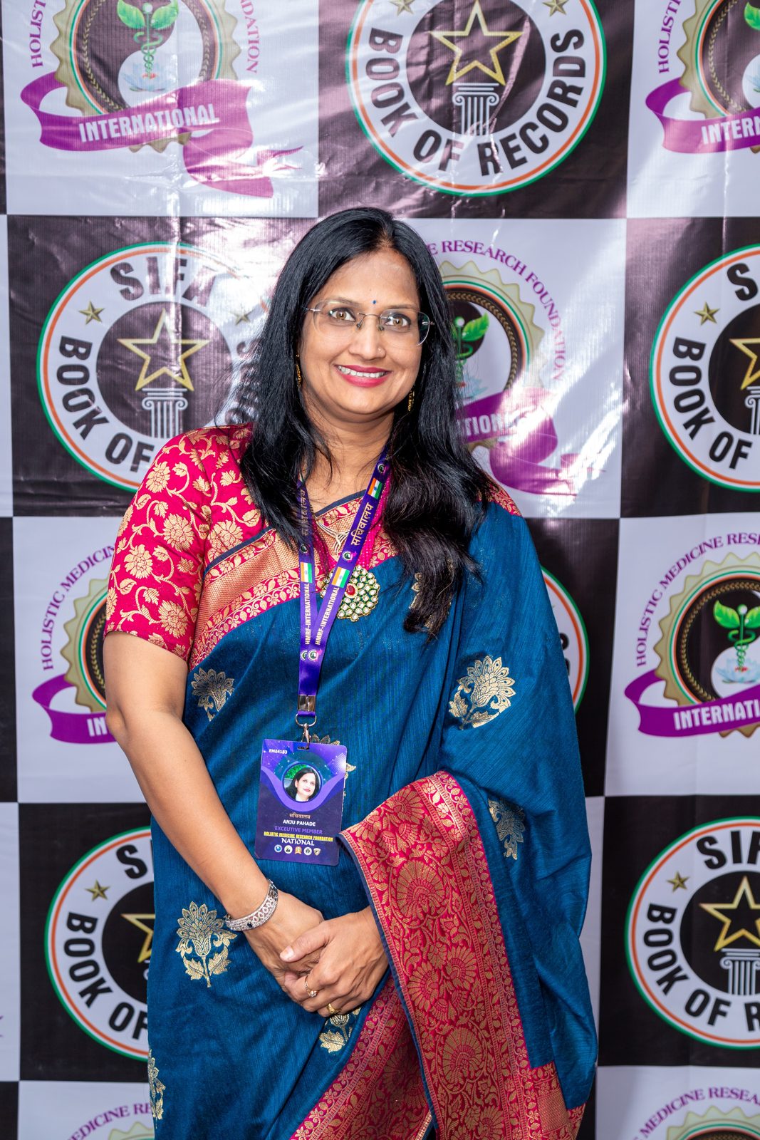 Anju Pahade receiving an award trophy